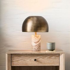 a table lamp sitting on top of a wooden dresser