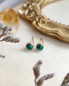 Genuine Malachite Stud Earrings 4 mm with choices of 14K Gold filled, Rose Gold Filled and Sterling Silver 💚  * Gemstone Size: 4mm ✨Malachite gemstone meaning ✨ * Malachite is known as a stone of transformation. It opens the heart to harmony. Helps reveal and heal emotional pain. It has been used to bring ease during transitional times and personal growth.  * 14K gold-filled and Sterling Silver is known for its lasting quality. These earrings will last for decades and are considered lifetime pi Dainty Round Earrings For May Birthstone, Gemstone Meanings, Earring Cards, Green Gemstones, Unique Charms, Jewelry Earrings Studs, Handmade Earrings, Beautiful Earrings, Wire Wrapped