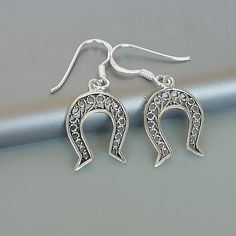 ONE PAIR of sterling silver horse shoe ear danglers. Dimensions: 12 x 17 mm Drop Length: 27 mm Weight: 1.06 gm These earrings are made of 925 hypoallergenic sterling silver. Please note this price is for ONE PAIR only. All my pieces are sent in a gift box. I can include a personal message from you if needed You are welcome to contact me at... bhavnakwintra1956@gmail.com For more beautiful pieces from my shop, please browse 👇 TOE RINGS: https://www.etsy.com/your/shops/TheSilverGame/tools/listing Silver Horseshoe Jewelry Gift, Nickel-free Horseshoe Sterling Silver Jewelry, Nickel-free Silver Horseshoe Jewelry, Elegant Horseshoe Earrings For Gift, Western Baddie, Shoe Earrings, Goodluck Charms, Country Jewelry, Silver Horse