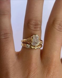 a woman's hand with a ring on it and a diamond in the middle