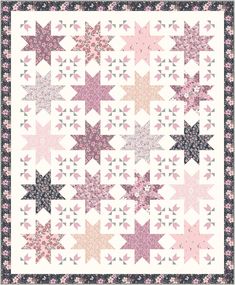 a pink and white quilt with stars on it