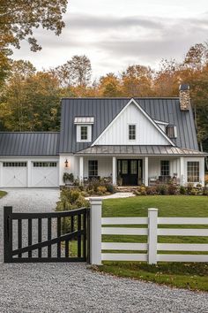 a large white house with a black gate