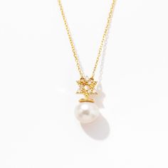 1- D E S C R I P T I O N Designed with a touch of elegance, this Diamond Star of David Pearl Necklace is a stunning 14k gold piece that exudes timeless beauty. The Star of David pendant, adorned with a pearl, adds a unique charm to this jewelry. Perfect as a gift for her, this necklace is more than just an accessory, it's a symbol of faith and love. Crafted with precision, it's a must-have for those seeking high-quality Star of David Pearl Jewelry. 2- P R O D U C T ∙ F E A T U R E S * Gold mater Elegant Star Of David Anniversary Jewelry, Elegant Star Charm Pendant Jewelry, Elegant 14k Gold Star Of David Jewelry, Elegant 14k Gold Jewelry With Star Charm, Elegant Star-shaped Jewelry For Gifts, Elegant Star-shaped Jewelry Gift, Elegant Star-shaped Formal Necklace, Elegant Star Necklace For Formal Occasions, Elegant Star Shaped Formal Necklace