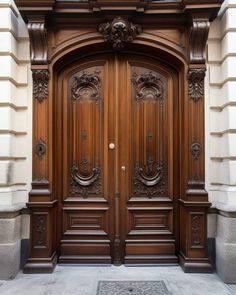 an ornate wooden door on the side of a building