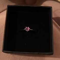 a pink diamond ring in a black box