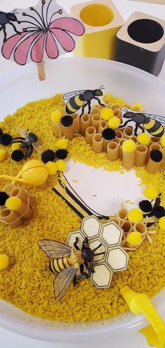 there is a cake decorated with bees and honeycombs on top of yellow rice