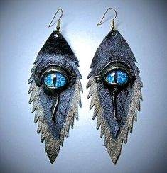 two pairs of earrings with blue eyes on them