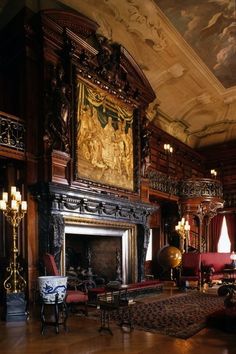 an ornate living room with wood paneling and paintings on the walls