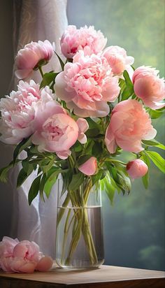 a vase filled with pink flowers on top of a table