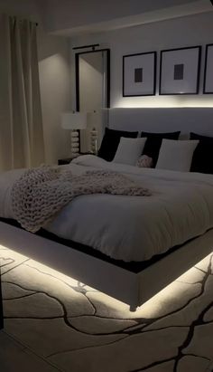 a large bed sitting in a bedroom next to two lamps on either side of it