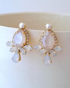 "Ivory cream earrings,Crystal Bridal earrings,Bridesmaid gift,Bridal jewelry,Ivory earring,Swarovski earring,Teardrop earring,Wedding earring Unique, elegant earrings. Can be made with any Swarovski colors. Please contact me. They are made of gold plated brass and Swarovski crystals. Made with CRYSTALLIZED™ - High-quality genuine Swarovski crystals. ✤ Available in other metal finishes at the drop-down menu. ✤ Matching bracelet available here: http://etsy.me/2EButhK ✤ Matching hair comb: http://e Glamorous White Dangle Teardrop Earrings, Glamorous White Teardrop Crystal Earrings, White Teardrop Earrings For Bridal Shower, Cream Teardrop Earrings For Wedding, White Teardrop Bridal Earrings For Bridal Shower, Elegant White Crystal Earrings For Bridesmaids, Glamorous White Teardrop Earrings For Wedding, White Teardrop Crystal Earrings, Glamorous White Crystal Wedding Earrings