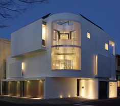 a large white building with lots of windows on it's sides at night time