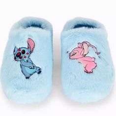 a pair of blue slippers with stitching on them