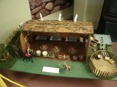 a model of a house made out of wood and other things on display at a museum