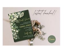 a wedding card with flowers and greenery on it