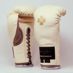 a pair of white boxing gloves sitting on top of each other