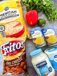 ingredients to make mexican chicken soup laid out on a counter top, including tomatoes, onions, peppers, and corn