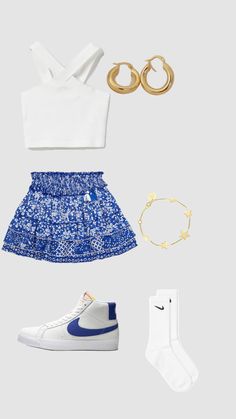 a white top, blue skirt and gold accessories are arranged on a gray background with space for text