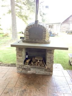 an outdoor brick oven with logs in it