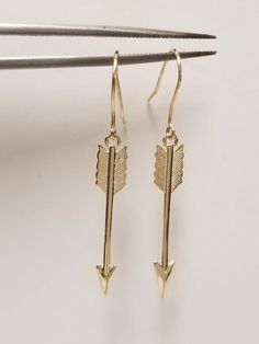 "Thanks for shopping our vintage estate store. We tend to sell well below wholesale and truly hope you enjoy all of our items. Many of the items are one of a kind, so please enjoy scrolling through the pictures and hopefully something will catch your eye. Brown spots are from camera. Nice estate 10k yellow gold love arrows earrings.  Size: 1.5\" by 4mm 1/4\" Weight: 1.51 grams Marked 10k and some that you will love." Nickel-free Heirloom Jewelry For Anniversary, Heirloom Nickel-free Jewelry For Anniversary, Classic Gold Earrings For Valentine's Day, Classic Drop Earrings For Valentine's Day, Vintage Nickel-free Earrings For Valentine's Day, Nickel Free Vintage Earrings For Valentine's Day, Vintage Jewelry With Ear Wire For Anniversary, Vintage Drop Earrings For Valentine's Day, Classic Hallmarked Earrings For Valentine's Day