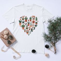 Show off your love for gardening with this stylish garden-heart T-shirt featuring a Scandinavian-inspired design of plants, birds, and gardening tools arranged in a charming heart shape. Perfect for plant lovers, green thumbs, and gardening enthusiasts who enjoy stylish garden-themed apparel. A great gift for gardeners, plant dads, and plant ladies who cherish their garden. Ideal for casual outfits or working in the garden with style.