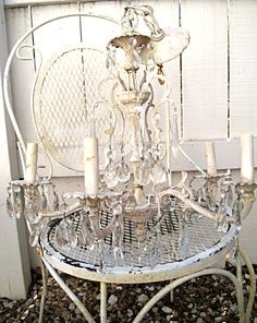 a white iron and glass candle holder