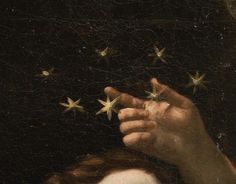 a close up of a person's hand holding stars