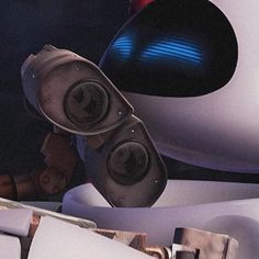 a close up of a robot with speakers on it's head and another person in the background