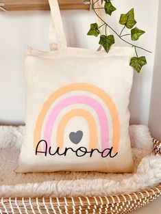 a white tote bag sitting on top of a chair next to a potted plant