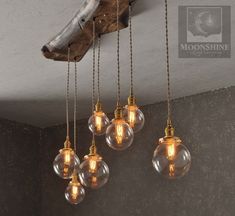 five light bulbs hanging from the ceiling in an old - fashioned style room with wood and stone walls