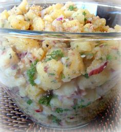 a glass bowl filled with food on top of a table