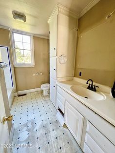 a bathroom with a sink, toilet and shower in it