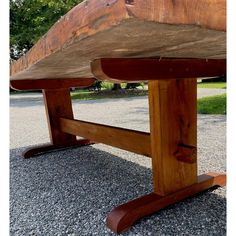 a wooden bench sitting on top of gravel