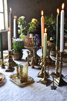 a table topped with lots of candles and dishes