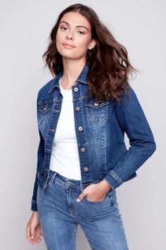 Charlies B's Denim Jean Jacket is a classic denim jacket style with brass hardware and a tailored look. Made in a stretchy cotton jean fabric that is soft and comfortable. A perfect go-to topper for just about any outfit! Updated cropped length falls just over waist on most. Vintage wash indigo. Two front chest pockets and two side pockets.Made in ChinaFabric: 73% Cotton, 23% Polyester, 3% Viscose, 1% SpandexCare: Wash Gentle, Hang to DrySize Medium (M): Bust 38", Hip 38", Length 21" Everyday Fitted Medium Wash Denim Jacket, Classic Fitted Medium Wash Denim Jacket, Fitted Denim Jacket In Dark Wash With Button Closure, Classic Fitted Dark Wash Denim Jacket, Fitted Denim Jacket With Button Closure In Dark Wash, Everyday Fitted Denim Blue Jacket, Dark Wash Fitted Denim Jacket For Everyday, Fitted Dark Wash Denim Jacket For Everyday, Everyday Fitted Dark Wash Denim Jacket