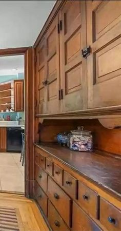 an open kitchen with wooden cabinets and tile flooring