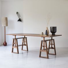 two wooden tables sitting next to each other in a room