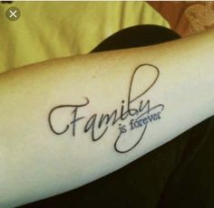 a person with a tattoo on their arm that says family is forever in cursive writing