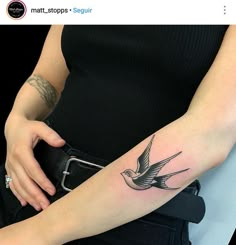 a woman with a bird tattoo on her arm