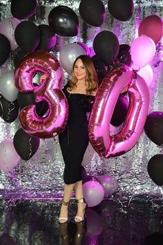 a woman standing in front of balloons that spell out the number thirty five, and an image of her