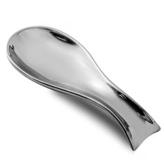 a silver spoon sitting on top of a white surface