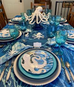 the table is set with blue and white dishes