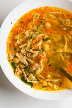 a white bowl filled with soup on top of a table