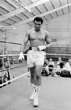 an old photo of a man wearing boxing gloves