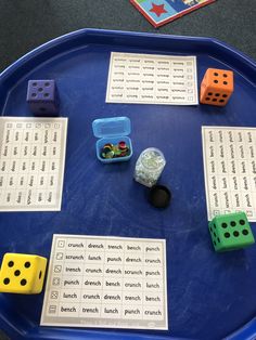 a blue tray with dice and other items on it