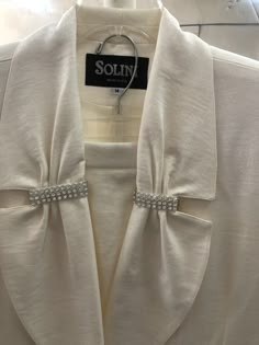 "1980's evening suit.   Cream colored two piece jacket and skirt.  Rhinestone embellishment at lapeland pockets with decorative button at jacket closure and shoulder pads.  Left leg slit in front.  Skirt has zipper in the back with elastic. Banded waist in the front.  Very \"Joan Collins\" Dynasty feel. Jacket chest:  44\" Sleeve 24\" Jacket length from neck to hem 30\" skirt side slit on left front 15\" waist to hem length 32\"" Joan Collins Dynasty, Long Suit Jacket, Evening Suit, Color Combinations For Clothes, Stunning Prom Dresses, Joan Collins, Summer Linen Dresses, Tie Neck Tops, Embroidery Designs Fashion