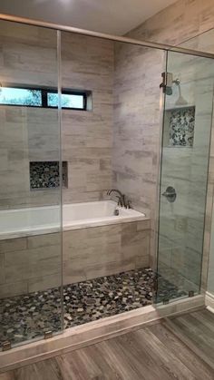 a bathroom with a walk in shower next to a bath tub