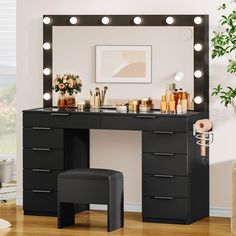 a black vanity with lights on it and a stool in front of the mirror that is lit up