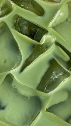 green liquid flowing down the side of a piece of food that looks like ice cubes