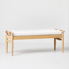 a wooden bench sitting on top of a white floor